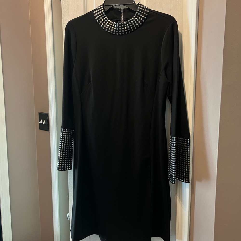 VENUS black dress w/ rows of round silver hardware detail around neck and cuffs.
